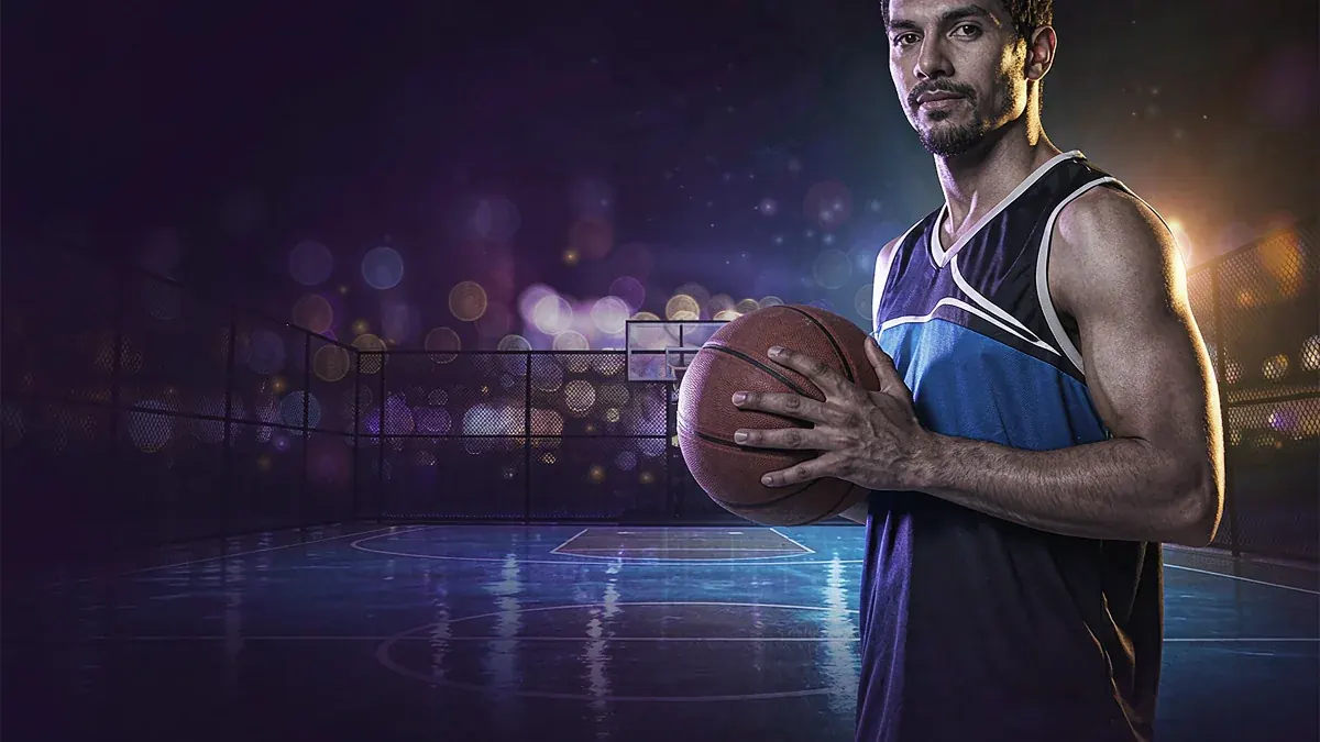Basketball player holding a ball on an outdoor court — Jita Ace